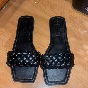 black slide sandals with woven design